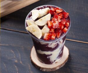Brazilian frozen açaí in a plastic cup with condensed milk an